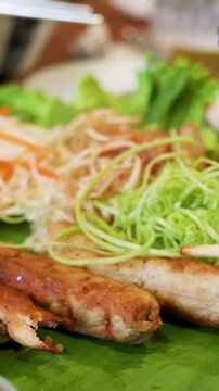 Vietnamese Nem Nuong Grilled Pork Skewers Served with Fresh Herbs and Vegetables