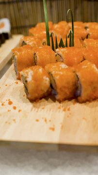 Assorted Japanese Sushi Rolls on Wooden Trays at International Buffet