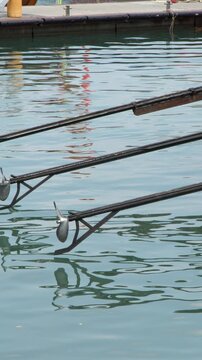 Longtail Boat Propeller Shafts Over Turquoise Water in Krabi Marina