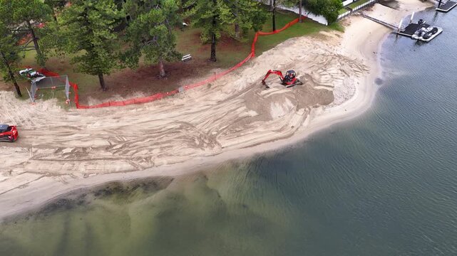 Aerial View of Excavator Renovating a Canal Beach in Gold Coast