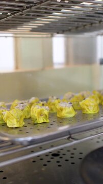 Serving Steamed Pork and Shrimp Siu Mai Dumplings at a Buffet