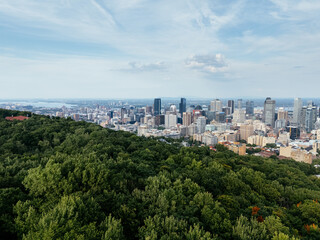 Obraz premium Montreal downtown skyline from Mount Royal with park, lake and greenery in summer, Quebec, Canada. g.