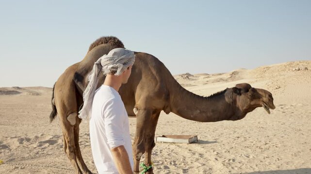 Slow Motion Tourist Walking Towards Black Camel, Cinematic Desert Encounter in Rub' al Khali Empty Quarter Oman