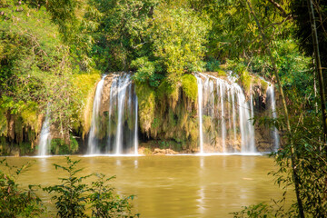 Fototapeta premium Tropical Jungle Waterfall Tiered Cascade Green Pond Wide Vista