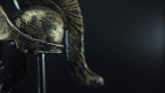 Detailed macro of Spartan warrior helmet rotating, water droplets, dramatic glow lighting