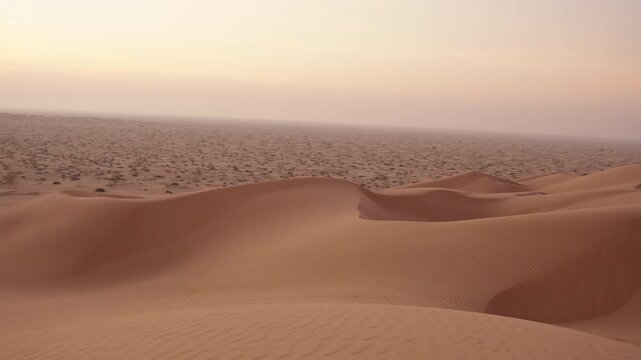 Slow Motion Panning Shot of Pink Sand Dunes at Sunrise, Cinematic Rub' al Khali Desert Horizon in Oman