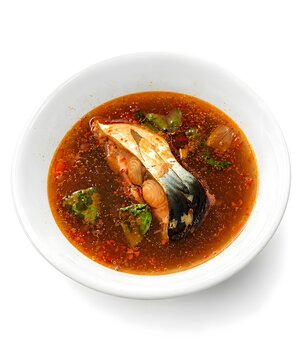 High-angle shot of Pindang Patin, a legendary river fish soup from Palembang, Indonesia. The photo showcases the rich cultural heritage of Sumatra with its bold spices, sweet-savory pineapple notes, a