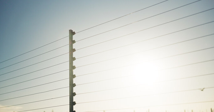Outdoor, safety and electrical fence with security, high voltage circuit and boundary for protection. Wire, barrier and system with powerline for prohibited entry, crime defense and access control.