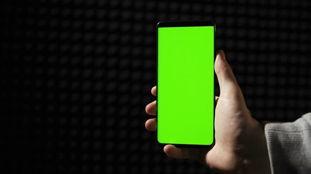 Smartphone with Green Mock-up Screen Doing Swiping Scrolling Gestures Point of View Shot Internet Social Networks Browsing