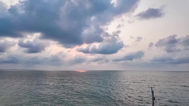 Serene Ocean Vista: A tranquil seascape where the ocean meets the vast sky, punctuated by dramatic cloud formations during the golden hour, an invitation to a peaceful state of mind.