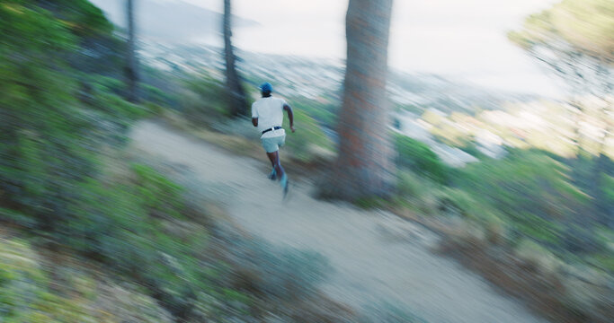 Fitness, black man and running in forest with motion blur, body health and cardio endurance workout. Person, back and fast runner in woods for exercise, speed or high intensity interval training