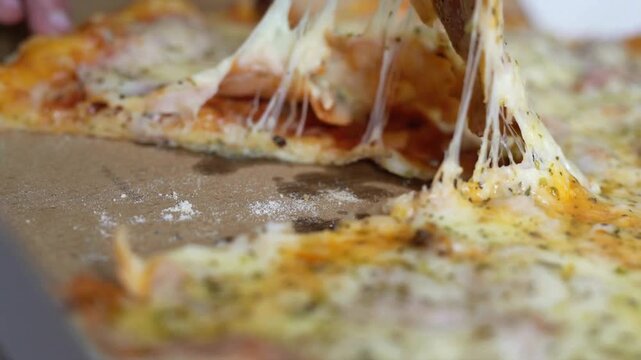 Meal time at pizzeria, man taking a slice of the pizza shot with very thin depth of field. Frame. Hand cut slice of pizza and take it, close up,