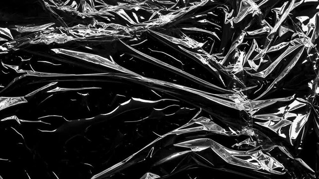 transparent plastic film wrap overlay texture on black background stop motion