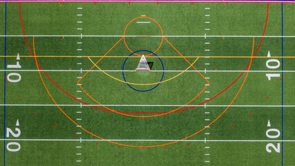 Aerial view of a multi-purpose athletic turf field featuring a lacrosse goal within a blue circular crease and overlapping colored lines for different sports.  Lacrosse, Soccer, Field Hockey, Football © Thomas