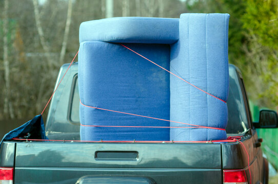 sofa secured in a back  of a pickup
