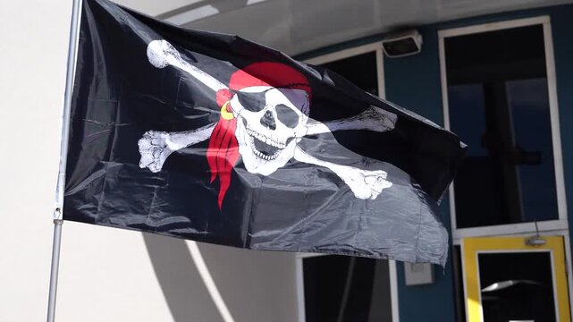 Pirate jolly roger flag flying in the wind