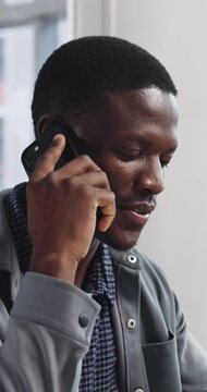 Smile, speaking or black man with phone call in office, manuscript feedback or creative project update. Mobile, draft revision tips or screenwriter with production negotiation, story pitch or talking