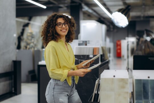 Woman shopping for home decor tiles in showroom