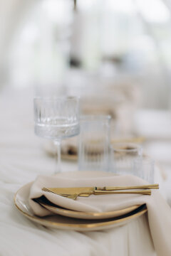Elegant table setting with gold cutlery for wedding reception