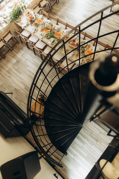 Overhead view of banquet tables and spiral staircase