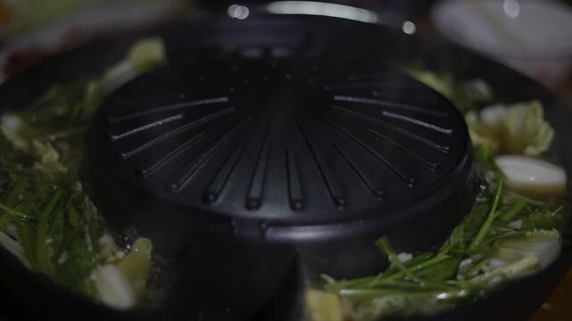 Cooking Vegetables Meat Shabu Hot Pot BBQ Grill Pan, A vibrant video of vegetables and meat sizzling on shabu hot pot BBQ grill pan, capturing authentic dining, for food documentary and culinary.