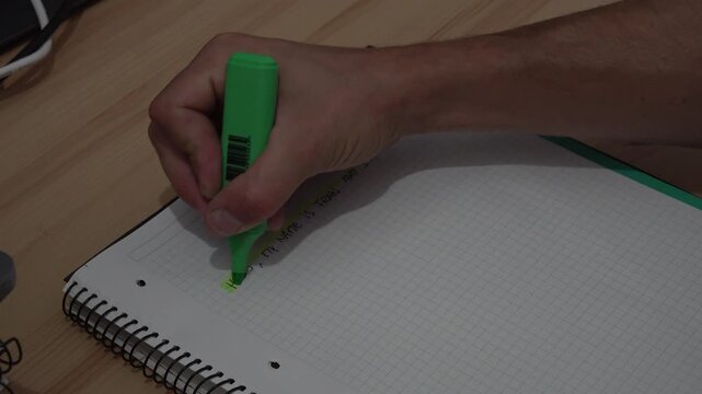person underlining a sentence in a notebook. High quality 4k footage