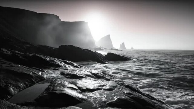 Dramatic black and white landscape of ocean waves crashing against rocky coastline under a bright sun