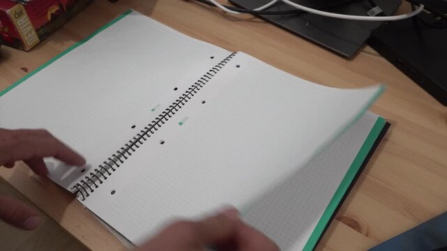 person turning the pages of a notebook from one side to the other. High quality 4k footage