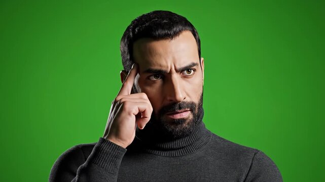 Close-up of a bearded man in a turtleneck thinking, concentrating, and having a moment of realization.