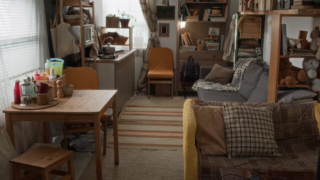 No people shot of interior of small lived in studio poor family apartment with old furniture and clutter