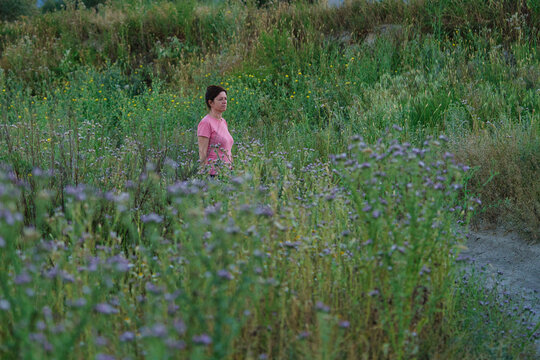 woman walks through the orchard