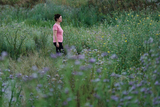 Woman enjoys a walk in the countryside