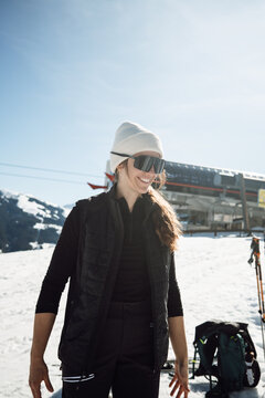 Smiling woman in ski gear at alpine resort