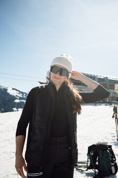 Smiling woman in ski gear at alpine resort