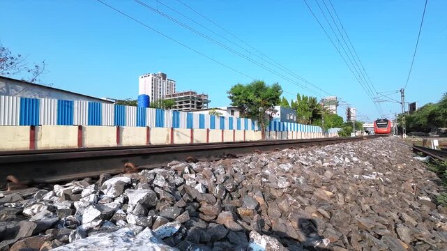 Saffron coloured Vande Bharat Express near Pune India. This is a made in India train set and also known as Train 18.