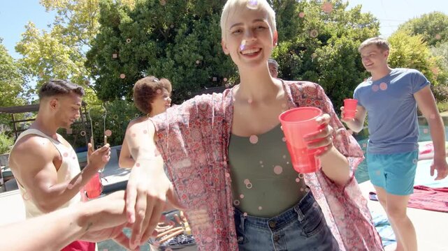 Nonbinary adult taking red cup from cam bumping hands twirling pool social grill confetti overlay