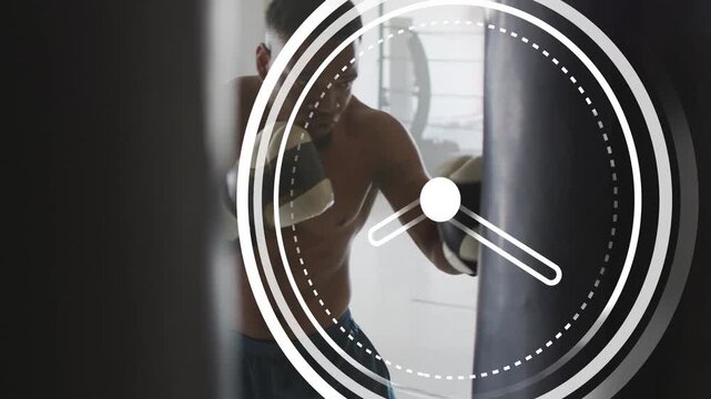 Male boxer throwing combos on heavy bag in gym, clock graphic drifting revealing form for fitness