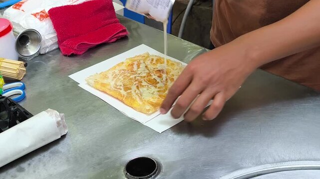 The process of making roti, a Thai street food dish.