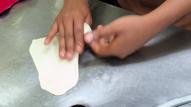 The process of making roti, a Thai street food dish.
