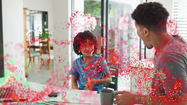 Father with mug raising hand urging child raising spoon and mimicking, particles sweeping parenting