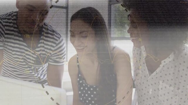 Team leaning over screen, center tapping pad, causing dashed circles and waves, celebrating tech