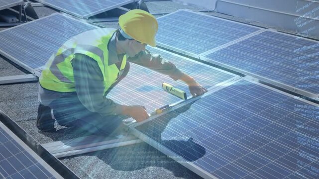 Technician kneeling on rooftop placing rail, checking level, aligning solar panels for max output