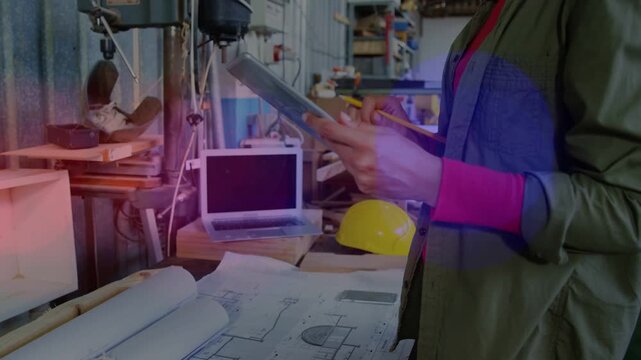 Female engineer touching tablet and marking blueprints, initiating review and finalizing design