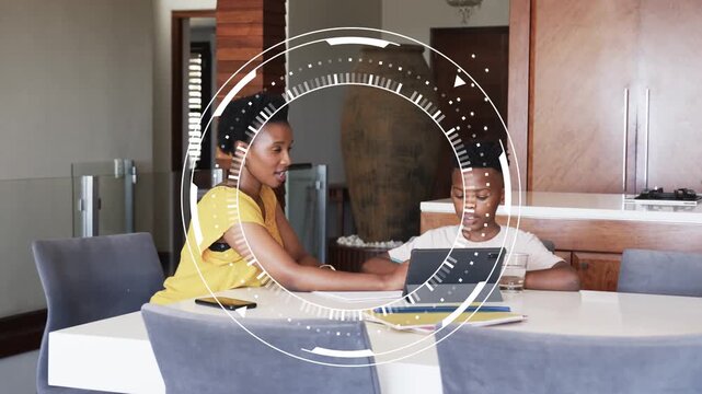 Mom pointing tab guiding son, tapping, shifting, HUD overlay aiding learning, dad entering with mug