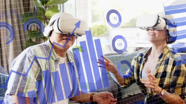 Couple placing white VR headset on sofa making blue data overlays gesturing analyzing business data