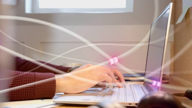 Man starting typing as hands move, coding while purple LED trails crossing hands and keyboard