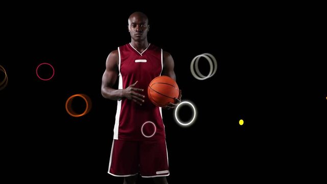 Player holding ball, neon shapes circling him, looking up, dribbling, ending two-hand grip for ads