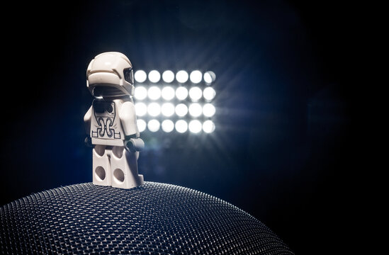 Gothenburg, Sweden - October 04 2017: Miniature astronaut standing on textured sphere under bright lights.