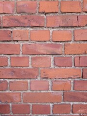 Fototapeta premium Macro Close-up of a Rustic Red Brick Wall, Detailed Texture of Weathered Masonry in Natural Daylight