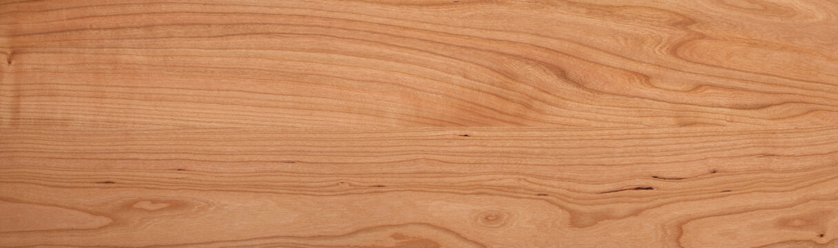 Solid wood tabletop background. Cherry wood plank texture. Cherry wood solid wood long tabletop.  wooden texture background
